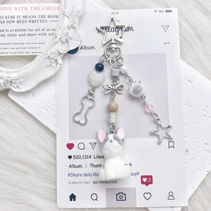 Cute flocked puppy keychain with blue beads and star charms on white plush background