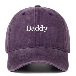 Close-up of white Daddy embroidery on purple washed cotton vintage baseball cap