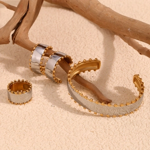 Two-tone stainless steel jewelry set with textured silver finish and gold bead edges