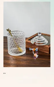 Macro detail of honeycomb textured glass candy jar with golden leaf spoon and lid