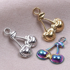 Macro shot of cherry-shaped stainless steel pendants in gold, silver, and rainbow colors
