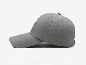 Detail of grey baseball cap featuring laser-cut ventilation holes and metallic logo