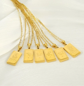 Detailed macro of 18K gold plated stainless steel square zodiac pendant necklaces