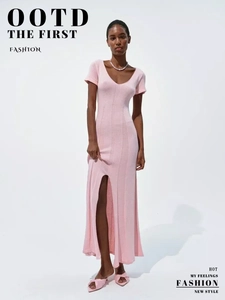 Detail of pink V-neck knit dress showing slim waist and high side slit design