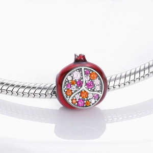 Macro shot of a red pomegranate charm with colorful pavé cubic zirconia for bracelets