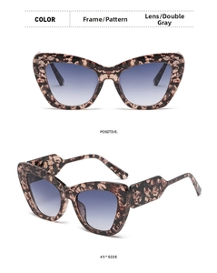 Detail view of cat eye sunglasses with tortoise frame and blue-grey gradient lenses