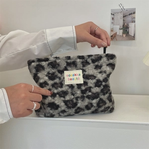 Detailed shot of plush leopard print makeup bag with a soft texture and zipper closure