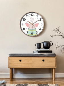 Minimalist wooden wall clock with pink cartoon pig on a plain beige wall in a living room