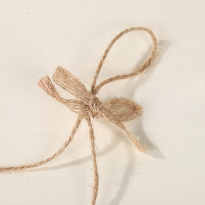 Close-up of handmade jute rope bow with natural fiber texture and rustic brown color