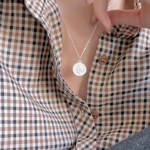 Silver 925 vintage coin pendant necklace featuring a round embossed medallion on a chain