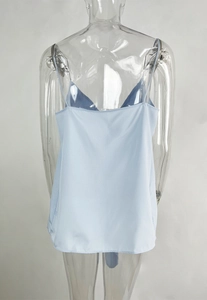 Detail of light blue satin camisole back with spaghetti straps on transparent mannequin