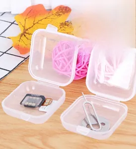 Mini clear plastic organizer box holding SIM card adapter and ejector tool on wooden desk