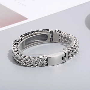 Macro view of vintage titanium steel bracelet with engraved black totem and clasp