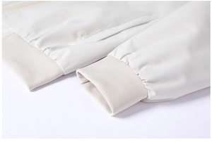 Detail of ribbed cuffs and pockets on a beige high-density fabric casual jacket