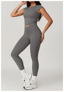 Detail of high-waist yoga leggings and cropped short-sleeve top in charcoal grey