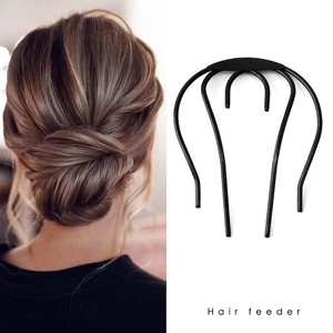 Minimalist U-shaped black hair fork tool for elegant bun hairstyles shown on model