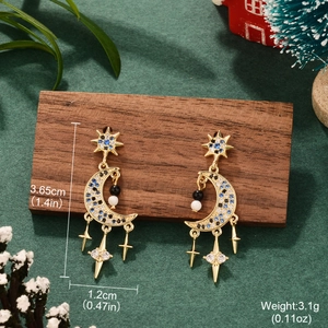 Detailed size view of gold star and moon earrings with blue stones and tassel charms