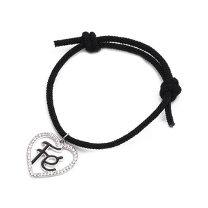 Adjustable black cord bracelet with micro-pave heart devil eye charm and Fe engraving