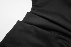Close-up of black high-density knit fabric showing fine texture and elegant drape