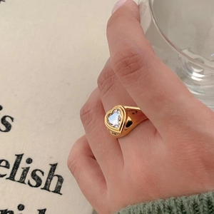 Minimalist 925 sterling silver gold heart ring with zircon stones worn by a model