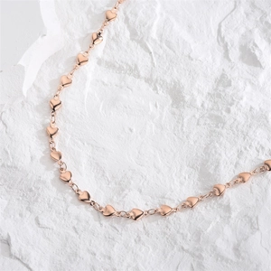 Elegant rose gold solid heart link necklace with high polish finish on white stone