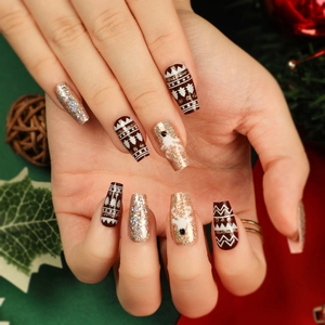 Christmas ballet-shaped fake nails featuring brown reindeer and gold glitter patterns