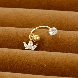 Detailed view of a gold C-shaped piercing ring with crown pendant and zircon stones