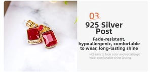 Macro shot of long red gemstone earrings with gold plating and 925 silver needles