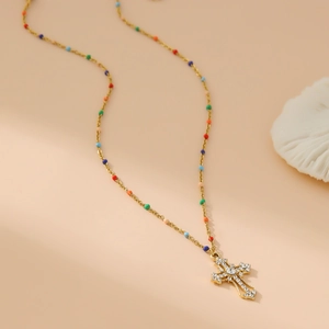 Golden stainless steel cross pendant necklace with multi-colored beads and sparkling crystals