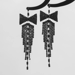 Detail of elegant black rhinestone bow earrings with long hanging tassels and stud fixings