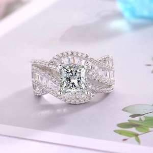 Makroaufnahme eines luxuriösen quadratischen Diamantrings mit gedrehten Details