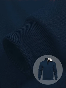Macro detail of navy waffle hoodie featuring white fleece lining and ribbed cuff texture
