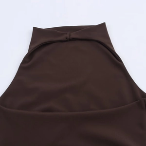 Detailed close-up of dark brown halter neckline with elegant pleated knit fabric textures
