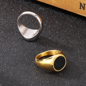 Detailed view of titanium steel signet rings in silver matte and gold with black enamel