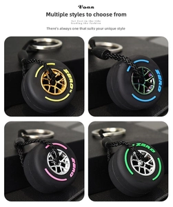 Detail of four colorful racing tire keychains with metallic rims and ZERO text engraving