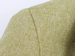 Close-up of the light olive green woven fabric with a detailed linen-like texture on the shoulder