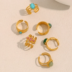 Detailed view of six 18K gold plated stainless steel rings with colorful natural stones
