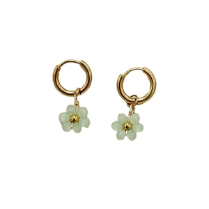 Gold hoop earrings with handmade pale green beaded flower pendants on white background