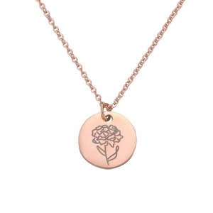 Macro shot of rose gold birthday necklace featuring engraved carnation flower pendant