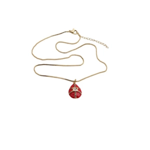 Detail of gold plated necklace with a red egg pendant inlaid with colorful zircons