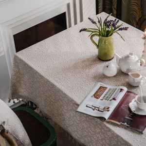 Linen cotton tablecloth with daisy print and tassel edges for a pastoral dining setting