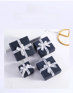 Navy blue jewelry boxes with white satin bow and fine texture for rings and necklaces