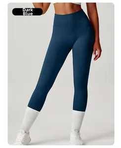 Detail showing high-waisted navy blue yoga pants with side pockets and ribbed waistband