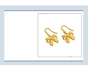 Detailed view of 18K gold plated bow earrings with sparkling rhinestone settings