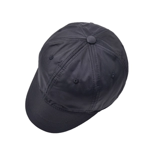 Detail view of black short brim baseball cap with six-panel soft crown construction
