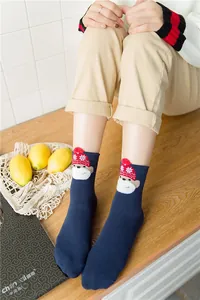 Navy blue cotton crew socks featuring a cute cartoon monkey with a red holiday hat