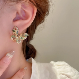 Detailed close-up of a golden butterfly earring featuring vibrant colorful zircons