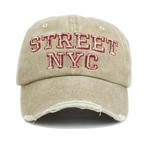 Close-up of distressed brim on khaki washed cotton baseball cap with NYC embroidery