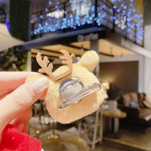 Close-up of a plush reindeer hair clip with antlers and a silver metal back clip