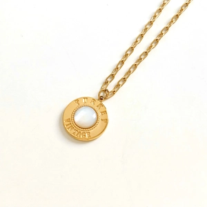 Minimalist vintage gold necklace with round shell pendant and turkey engraving detail